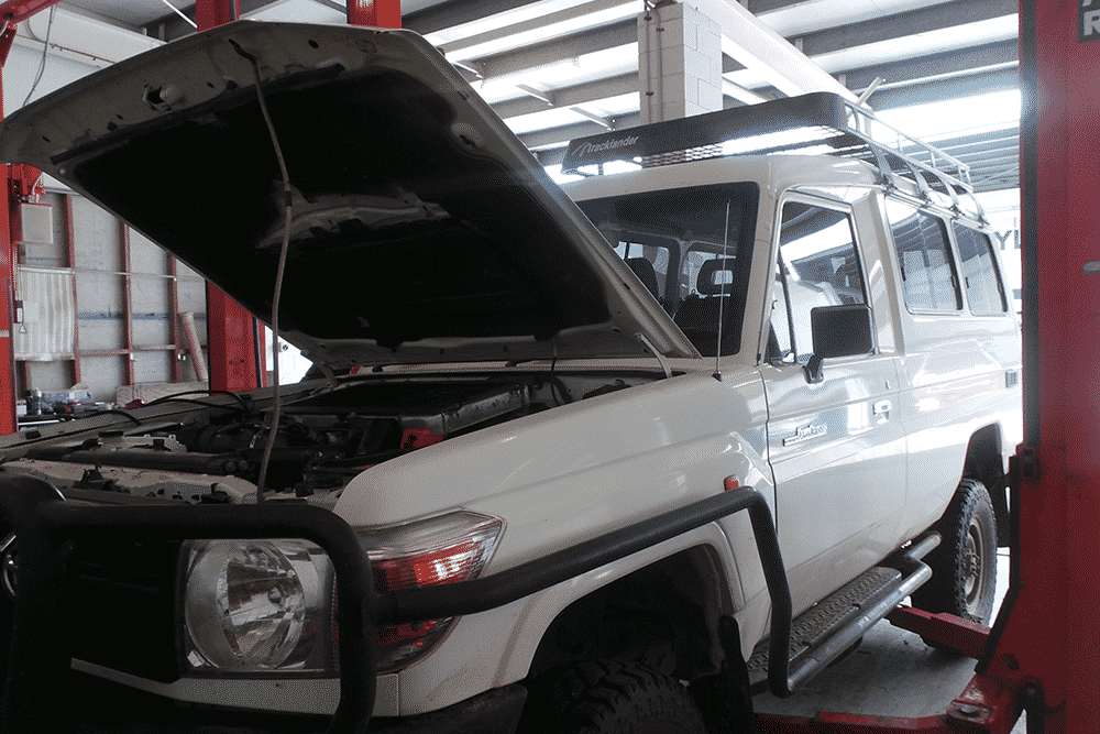 Car with hood open being serviced in Gladstone workshop